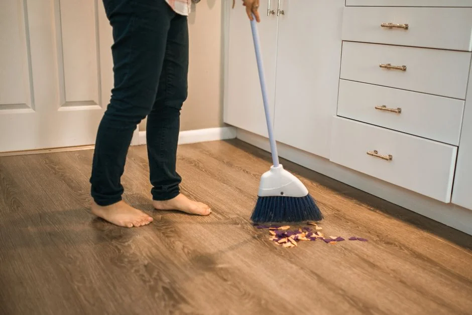 Close-up of a professional, fully protected, sanitizing an indoor surface.